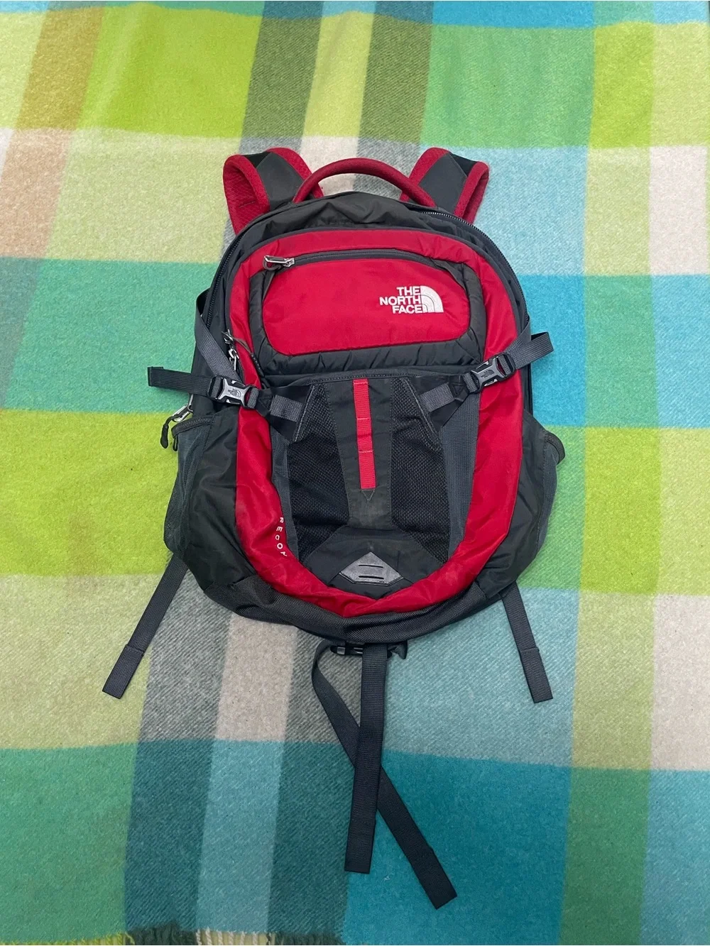 The North Face Recon backpack in charcoal gray and bright red